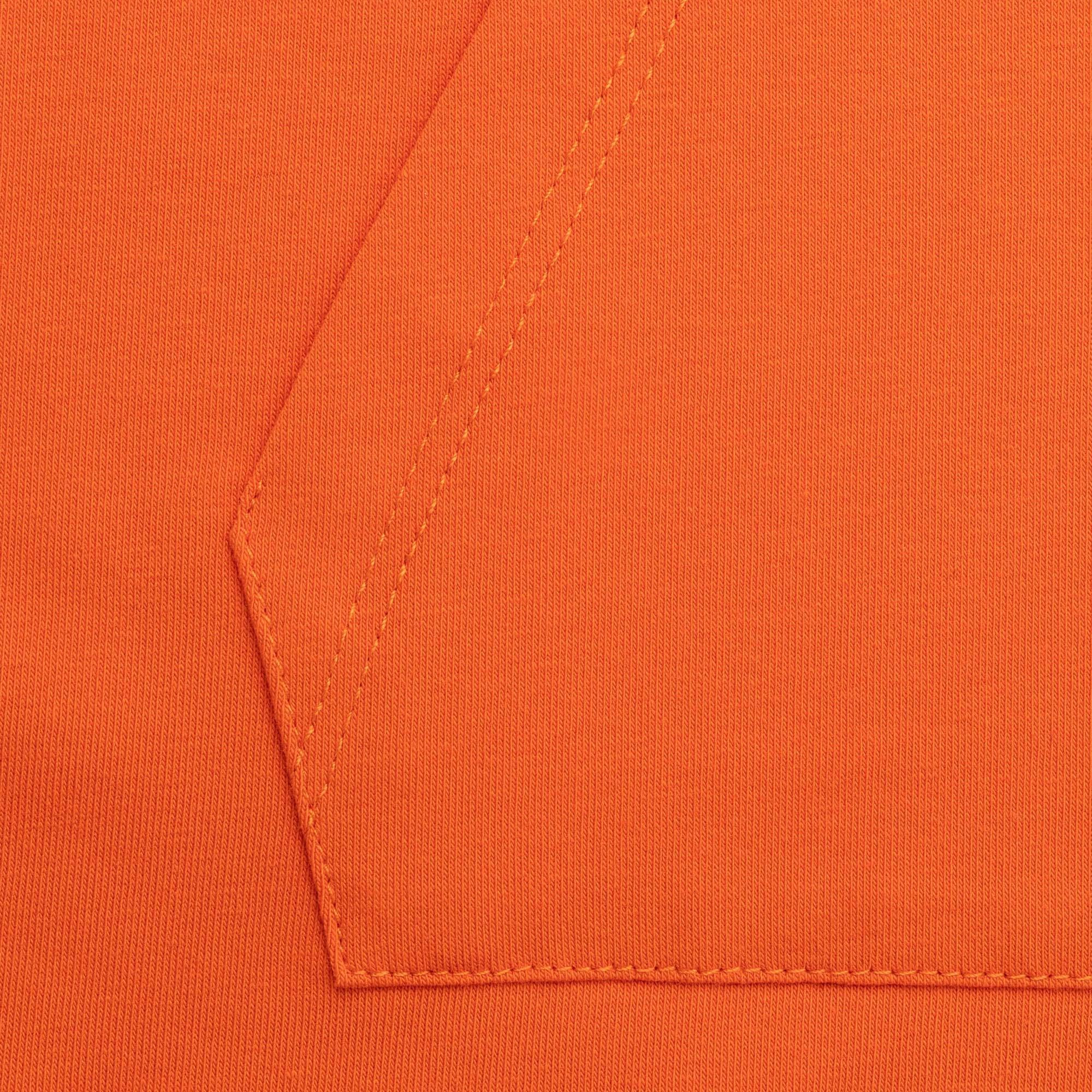 Pomarańczowa bluzka z kieszenią na przodzie